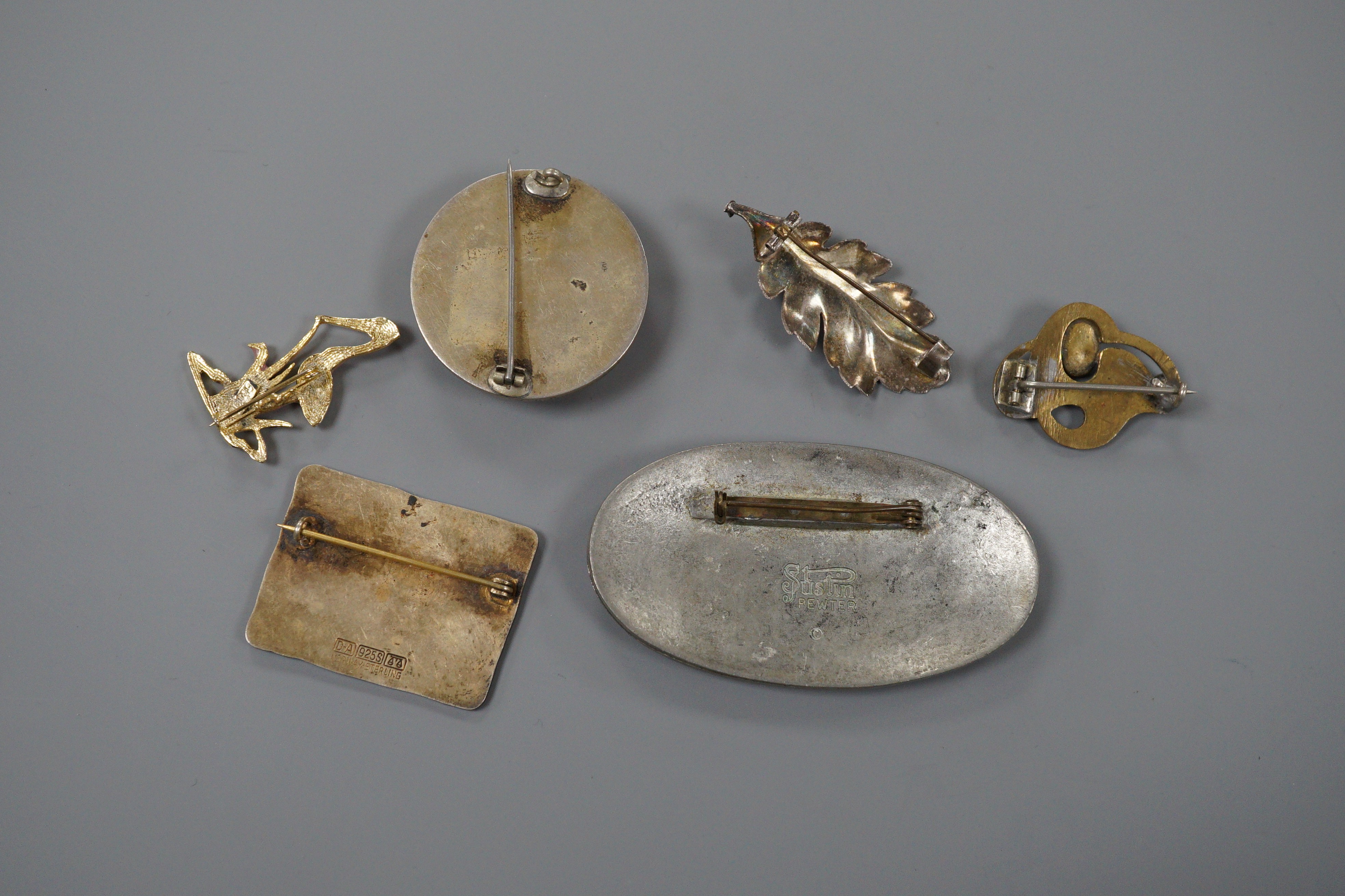 A Norwegian sterling and polychrome enamel set modernist brooch by David Andersen, 43mm and five other brooches including amber.